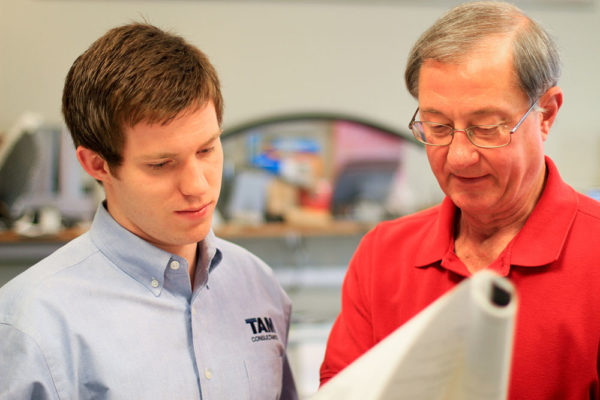Senior Engineer teaching young engineer about a career at TAM Consultants  